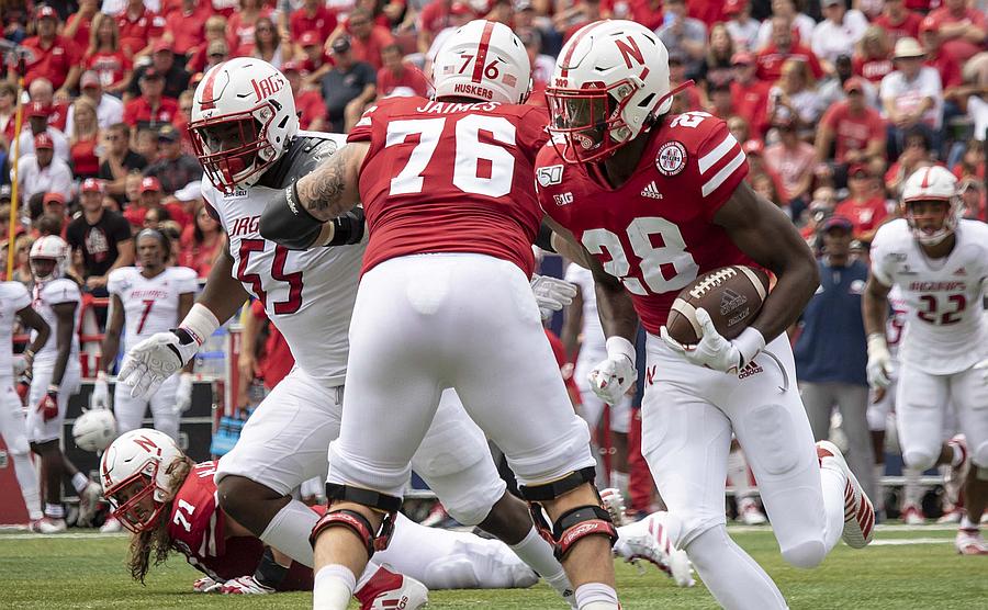 Which needs to improve most for the Huskers - running or passing?