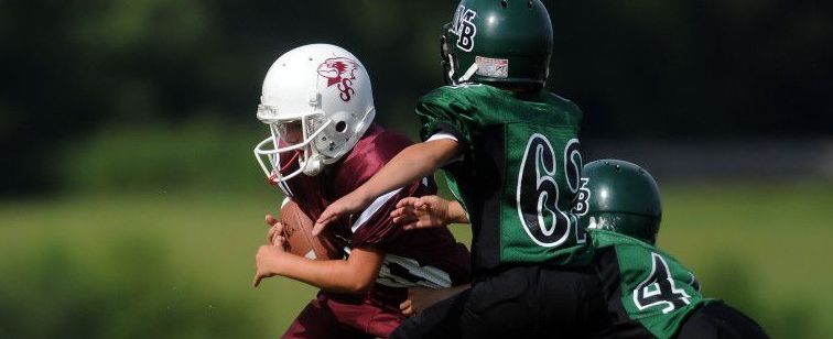 Is it OK for grade-school kids to play tackle football?