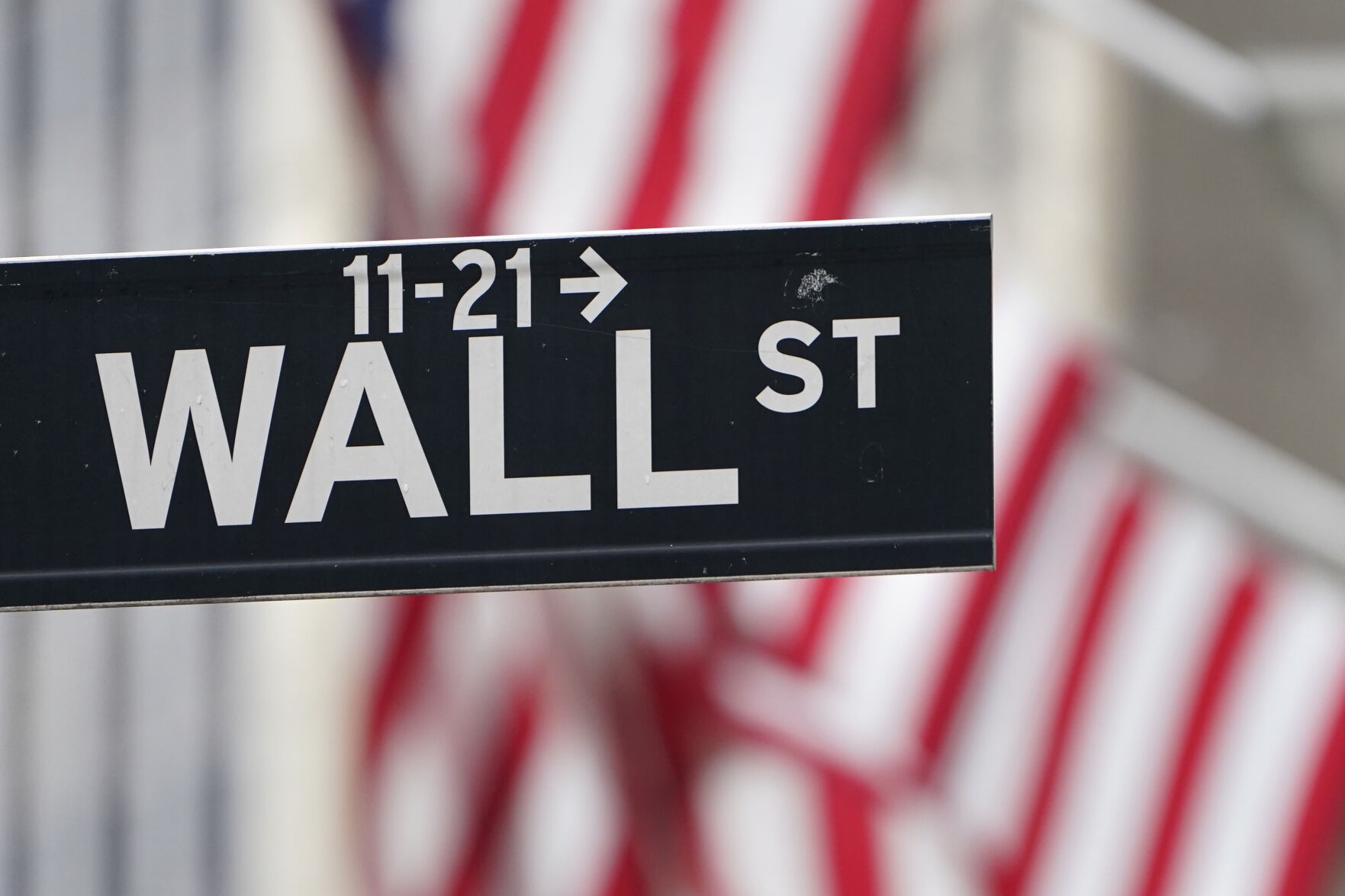 Should the Federal Reserve raise rates and curtail bond purchases designed to spark the economy?